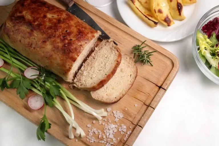Golden chicken meatloaf with herbs, served with roasted potatoes and fresh salad.