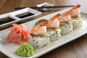 A beautifully plated shrimp sushi dish featuring fresh shrimp, sushi rice, and vibrant garnishes, perfect for sushi lovers.